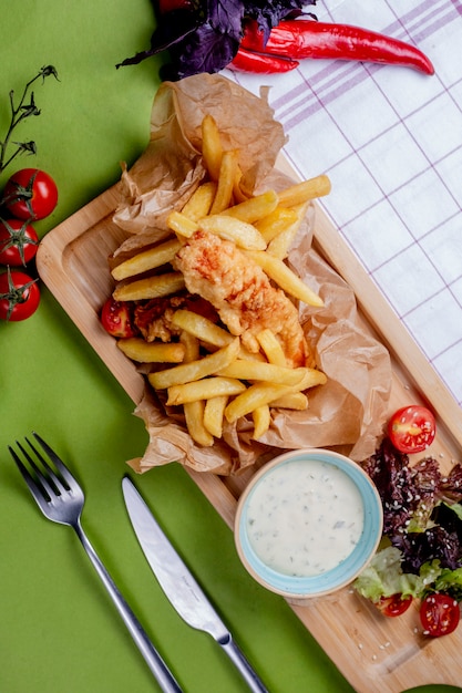 French fries mixed with nuggets and served with sour cream