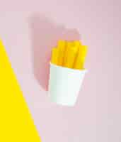 Free photo french fries replica on pink background