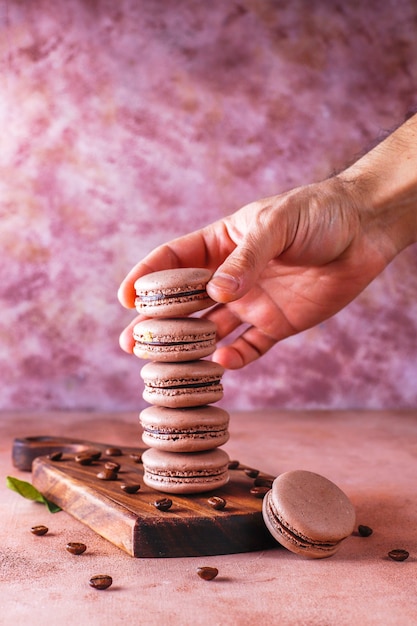 Free photo french macaroons with coffee beans.