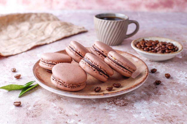 Free photo french macaroons with coffee beans.