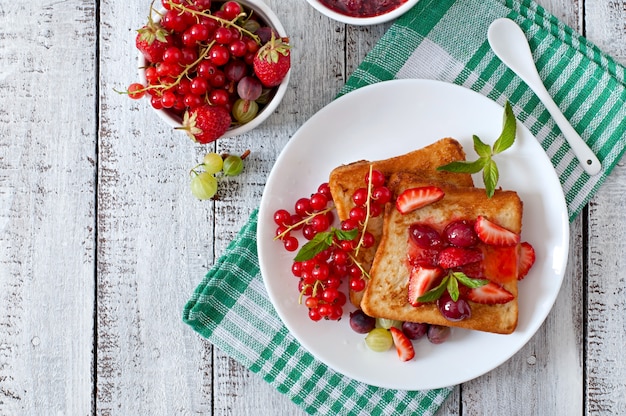 French toast with berries and jam for breakfast