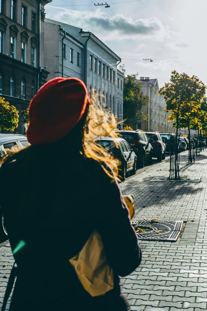 Free Photo french woman with baguettes on the street in beret