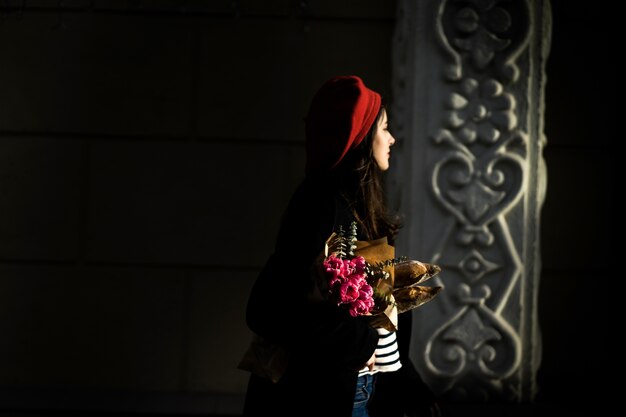 French woman with baguettes on the street in beret