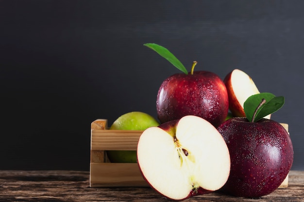 Free photo fresh apple in wooden box over black , fresh fruit