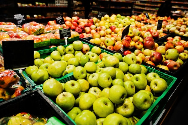 Fresh apples at boxes on supermarket