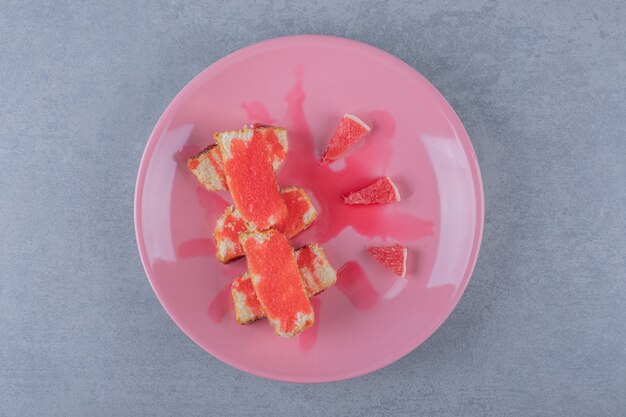 Fresh baked cake slices with grapefruit slices