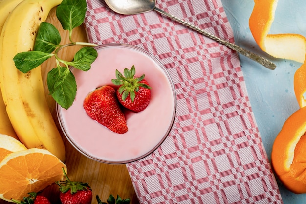 Fresh banana,orange and strawberries with a bowl of pudding