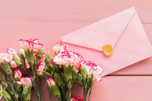 Fresh bouquet of flowers near envelope