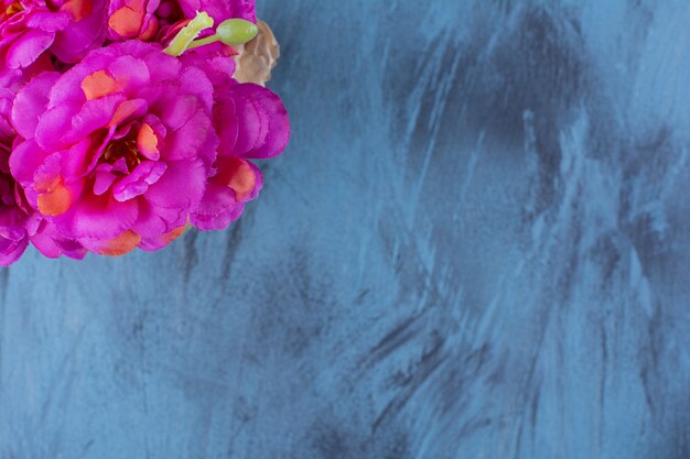 Fresh bouquet of fresh purple flowers on blue.