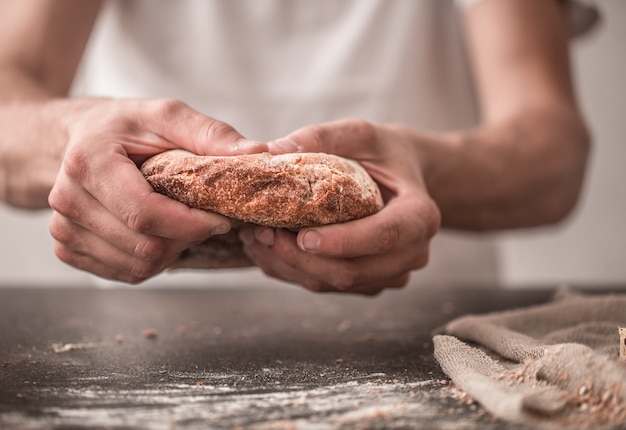 fresh bread in hands closeup on