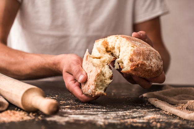 fresh bread in hands closeup on