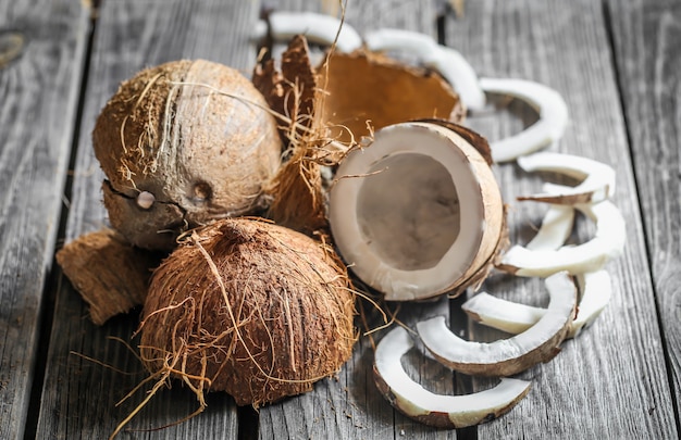 Fresh broken coconuts on wooden table