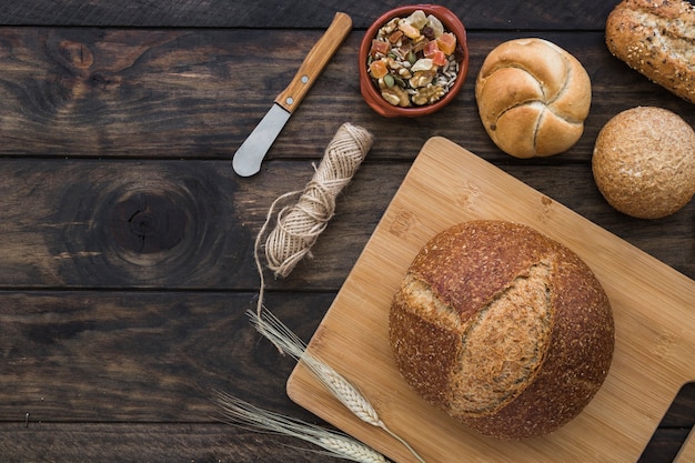 Fresh buns near candied fruits and tools