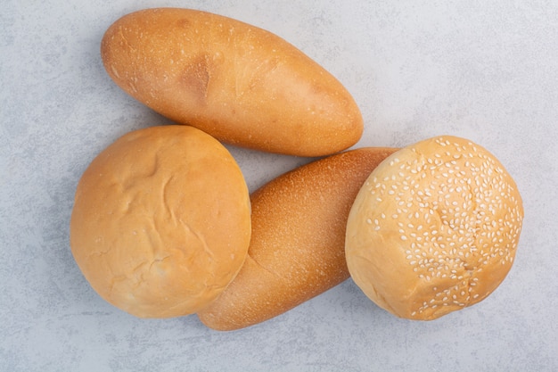 Free photo fresh buns with sesame seeds on stone surface