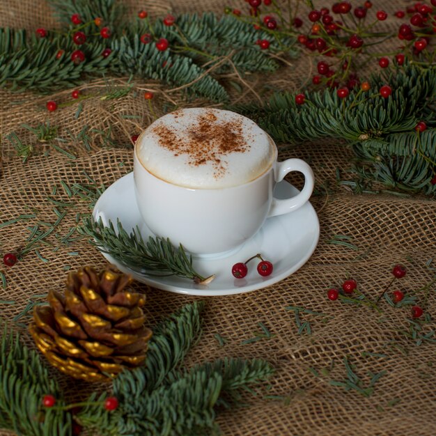 Fresh cappuccino in the cup on the table