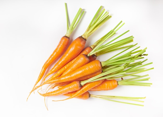 Free photo fresh carrot isolated on white surface as package design element. top view. flat lay. freshly from home growth organic garden. food concept.