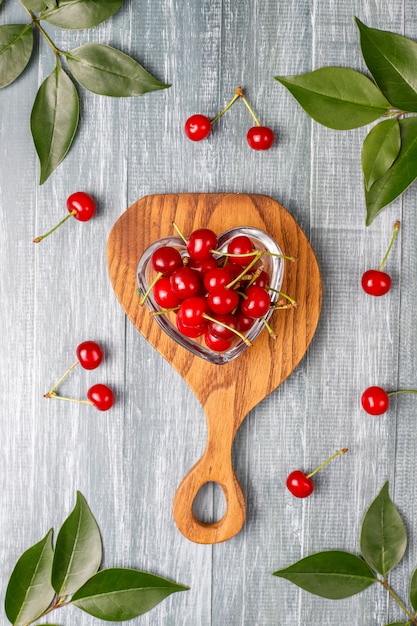 Free Photo fresh cherry on plate on wood table