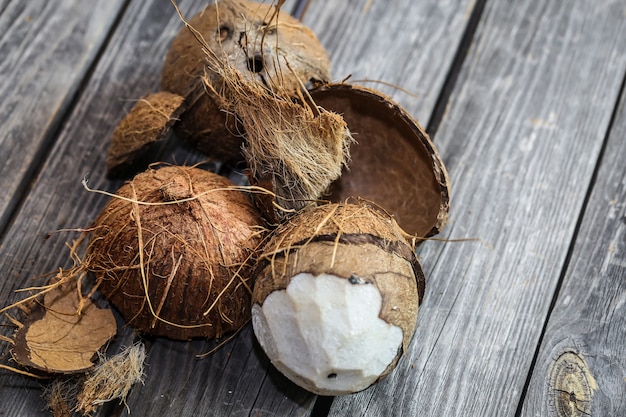 Fresh coconuts broken on wooden wall