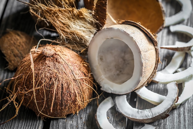 Fresh coconuts broken on wooden wall