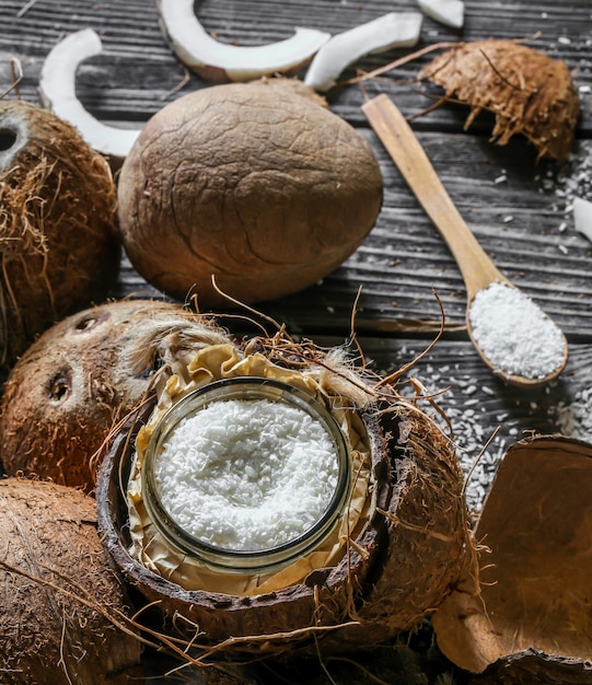 Free photo fresh coconuts broken on wooden wall