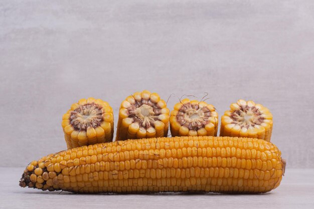 Fresh corns on white table.