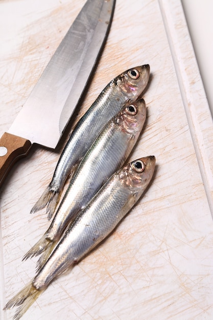 fresh delicious fish on cutting board with a knife