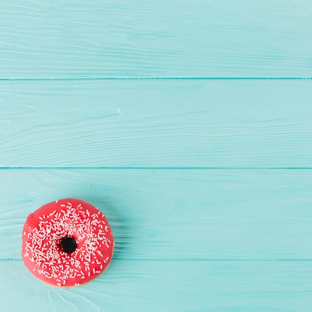 Free Photo fresh donut with sprinkles on wooden table