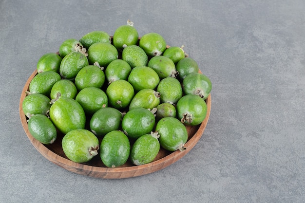 Free photo fresh feijoa fruits on wooden plate. high quality photo