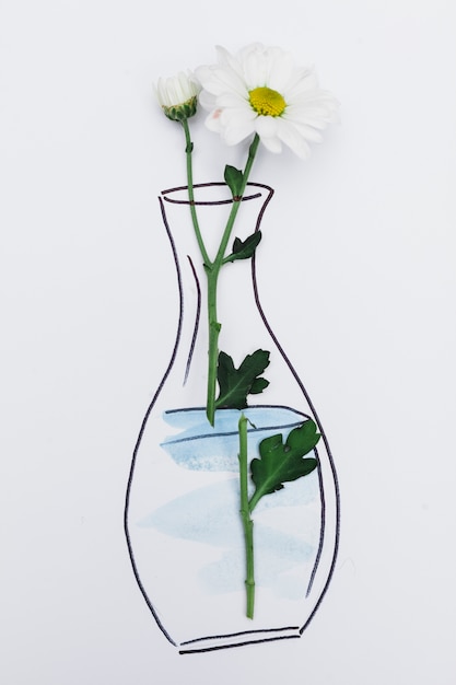 Free Photo fresh flower placed on paper with drawn vase