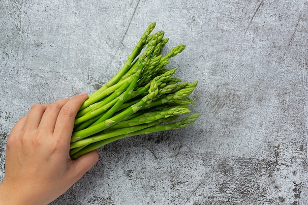 fresh green asparagus on old dark background