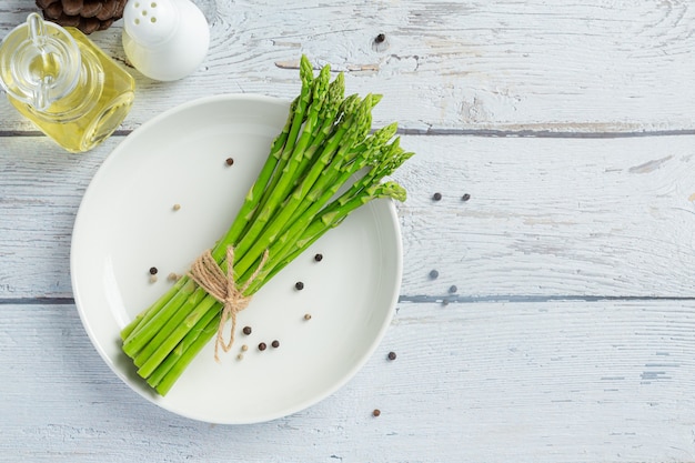 fresh green asparagus on wooden background