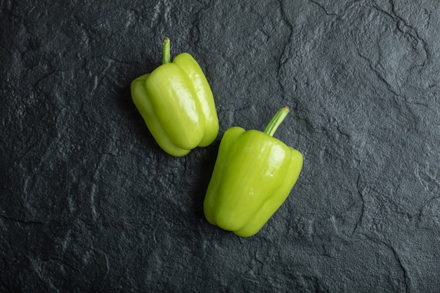 Free photo fresh green bell peppers on black.