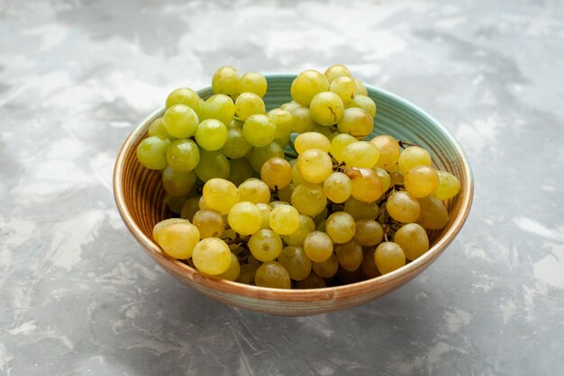 fresh green grapes inside plate on light