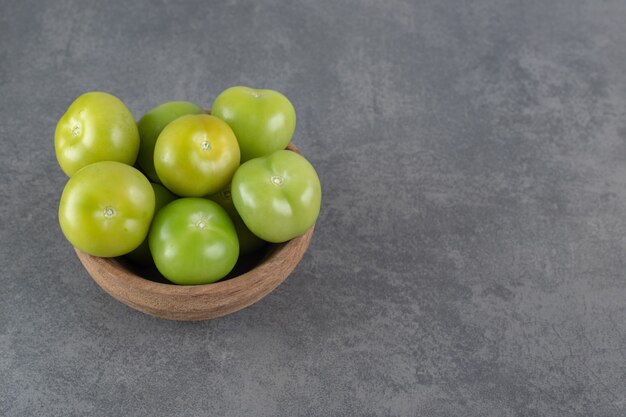 Fresh green tomatoes in wooden bowl. High quality photo