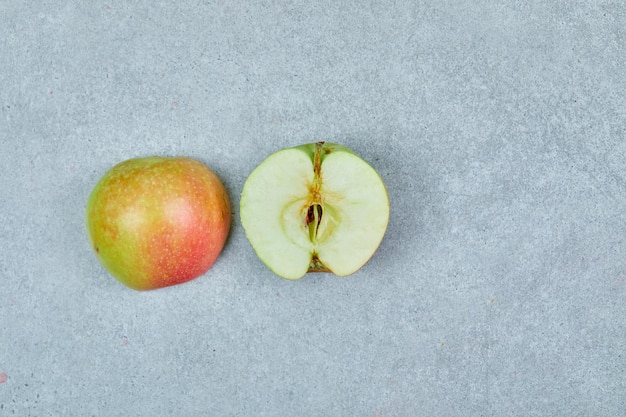 Fresh half cut apple on grey.