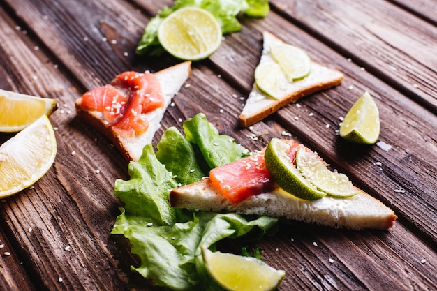 Fresh and healthy food. Breakfast or lunch ideas. Bread with cheese, avocado and salmon