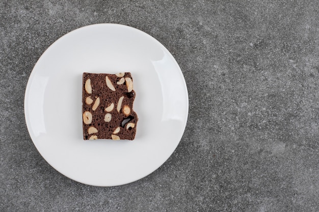 Fresh homemade cake slice on white plate. Peanut and chocolate. 