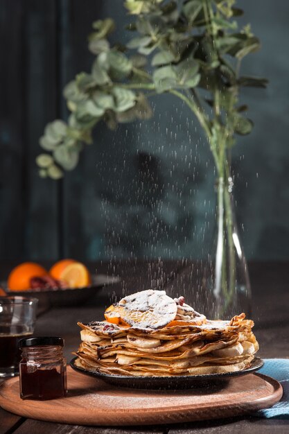 Fresh homemade french crepes made with eggs, milk and flour, filled with marmalade on a vintage plate