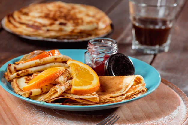 Fresh homemade french crepes made with eggs, milk and flour, filled with marmalade on a vintage plate