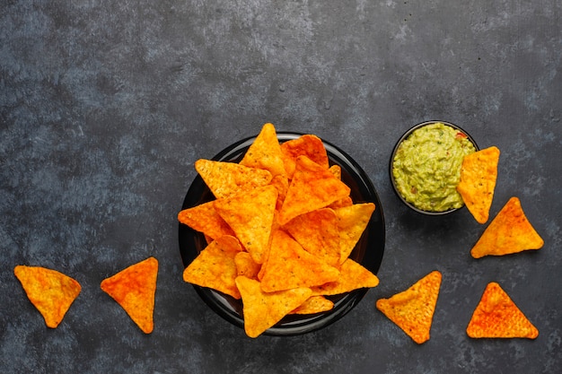 Free Photo fresh homemade hot guacamole sauce with nachos, top view