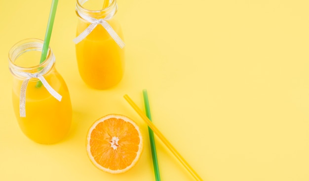 Free photo fresh homemade orange juice with straws