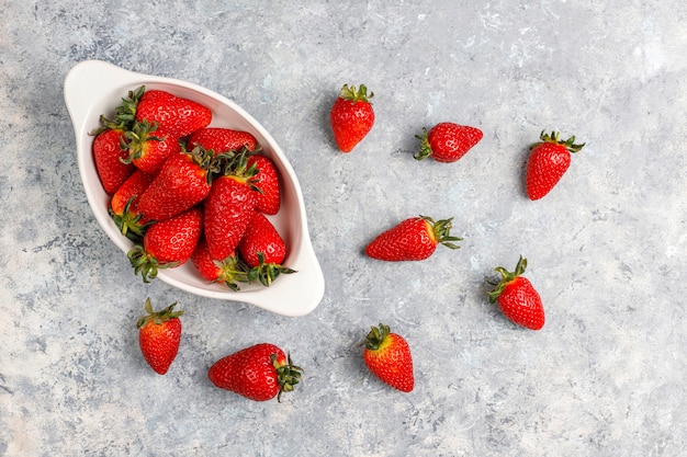 Fresh juicy strawberries on light background,top view