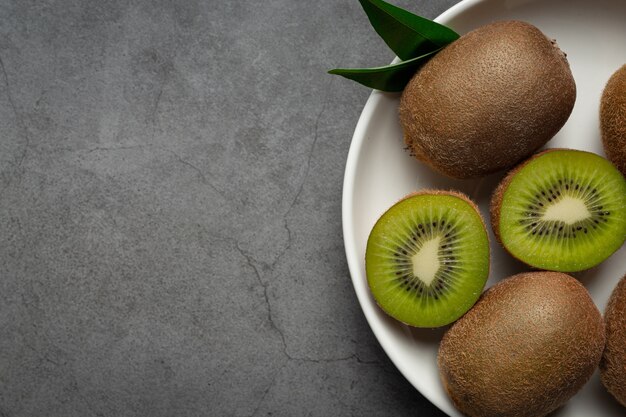 Fresh kiwi, cut into half, put on a white plate