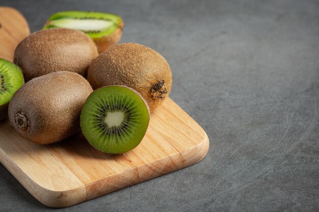 Fresh kiwi, cut into half, put on wooden cutting board