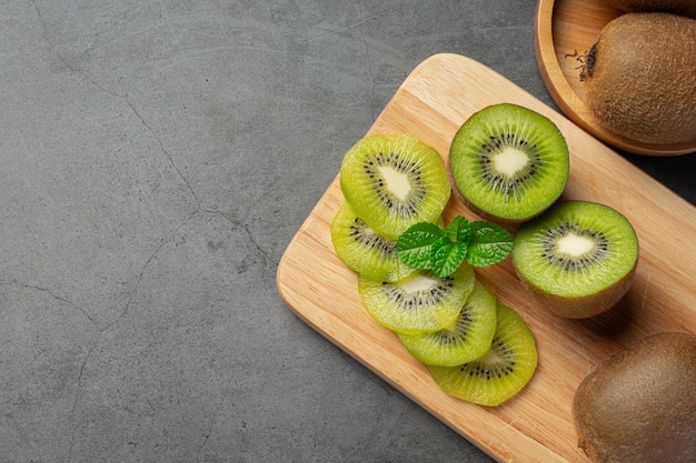 Fresh kiwi, cut into half, put on wooden cutting board