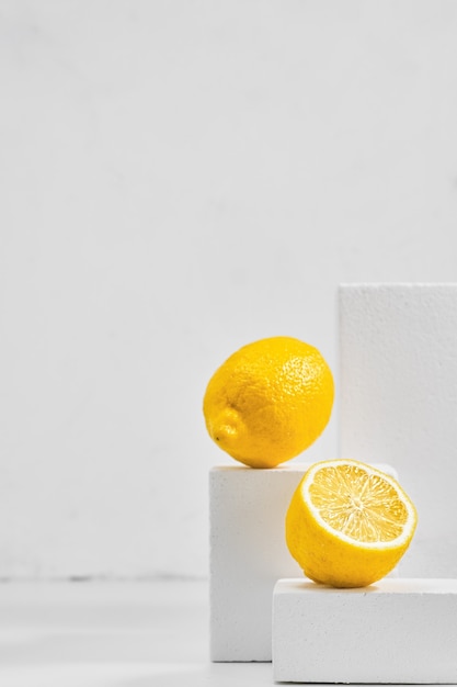 Fresh lemons on gray table, minimalistic concept with lemons