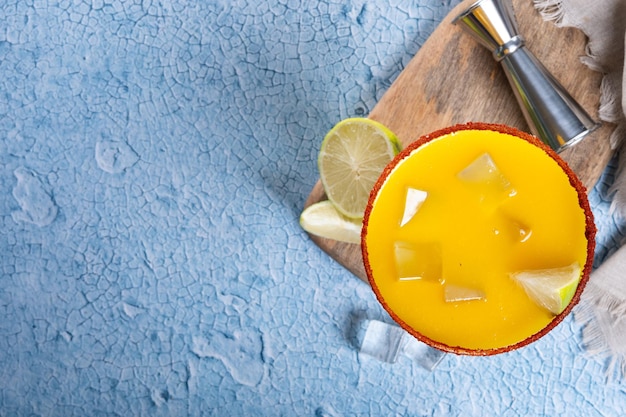 Fresh mango cocktail Mexican mango cocktail on blue background