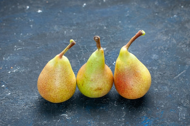 fresh mellow pears whole ripe and sweet fruits lined on dark desk