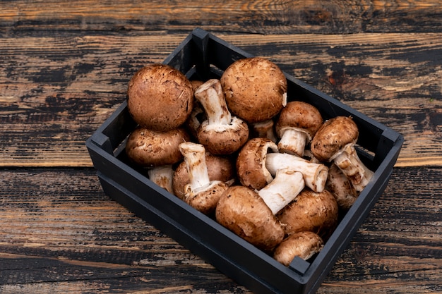 Fresh mushrooms in wooden box