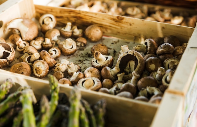 Fresh mushrooms in wooden tray at the farmers' market